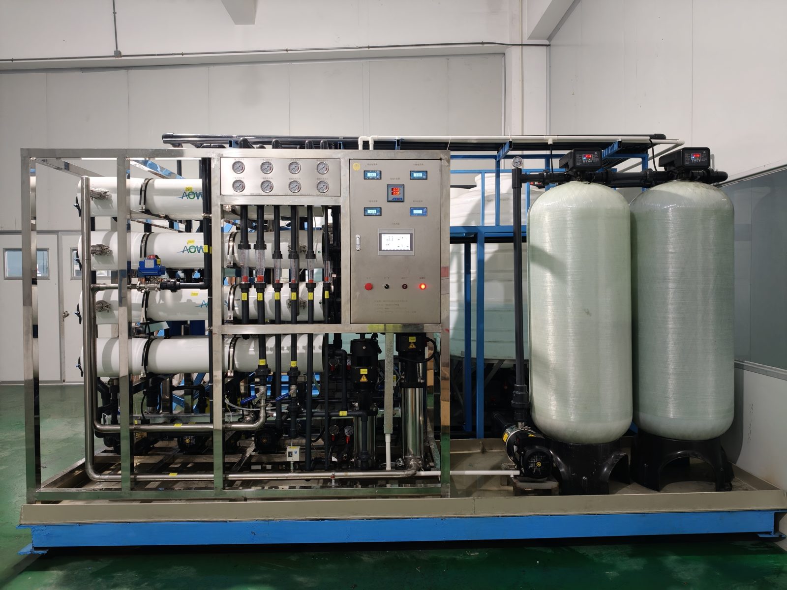 Industrial RO water system on blue skid with FRP pretreatment tanks